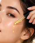 Applying Cosmecell Vitamin C + Peptide Serum with a dropper for a brighter, hydrated-looking glow