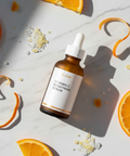 Cosmecell Vitamin C Serum 12% - Brightening flat lay with orange slices on marble